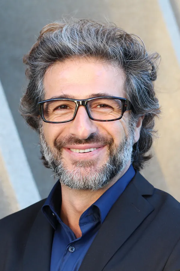 Andropause-and-Low-Testosterone-Treatment A man with glasses, salt and pepper hair and a beard smiling because he received treatment for andropause and low testosterone from Sandra McDonald, NP in Southwestern Ontario.