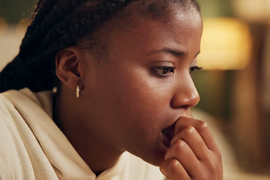 Anxiety-Clinic A black woman bites her nails with worry. Get treatment for anxiety from Sandra McDonald, NP in Southwestern Ontario.