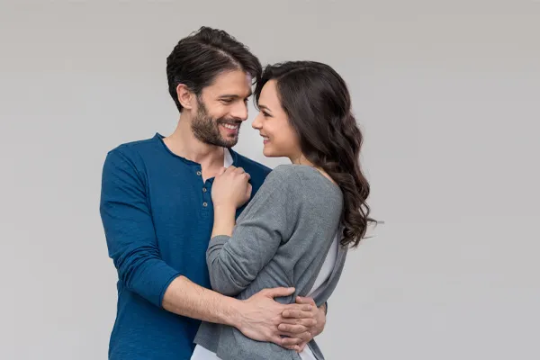 Erectile-Dysfunction-Doctor A man in a blue shirt embracing a woman in a gray shirt smiles due to his successful erectile dysfunction care from Sandra McDonald, NP in Southwestern Ontario.