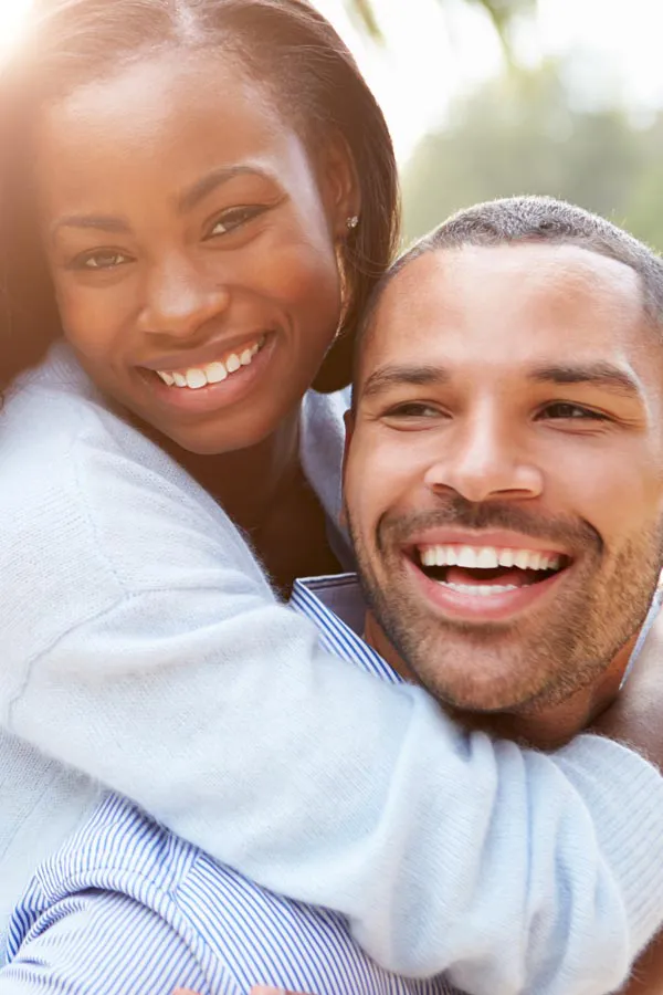 Erectile-Dysfunction-Treatment A woman riding on a man's back, both smiling due to help with erectile dysfunction from Sandra McDonald, NP in Southwestern Ontario.
