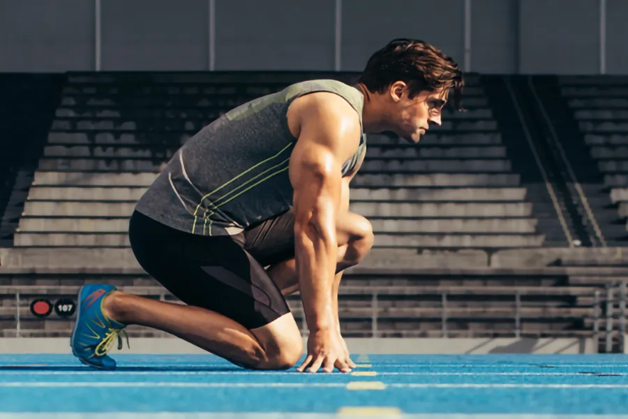 Lean-Muscle-and-Recovery-Clinic A white man kneels at the starting line on a track, determined to do his best. Get treatment for lean muscle loss and recovery from Sandra McDonald, NP in Southwestern Ontario.