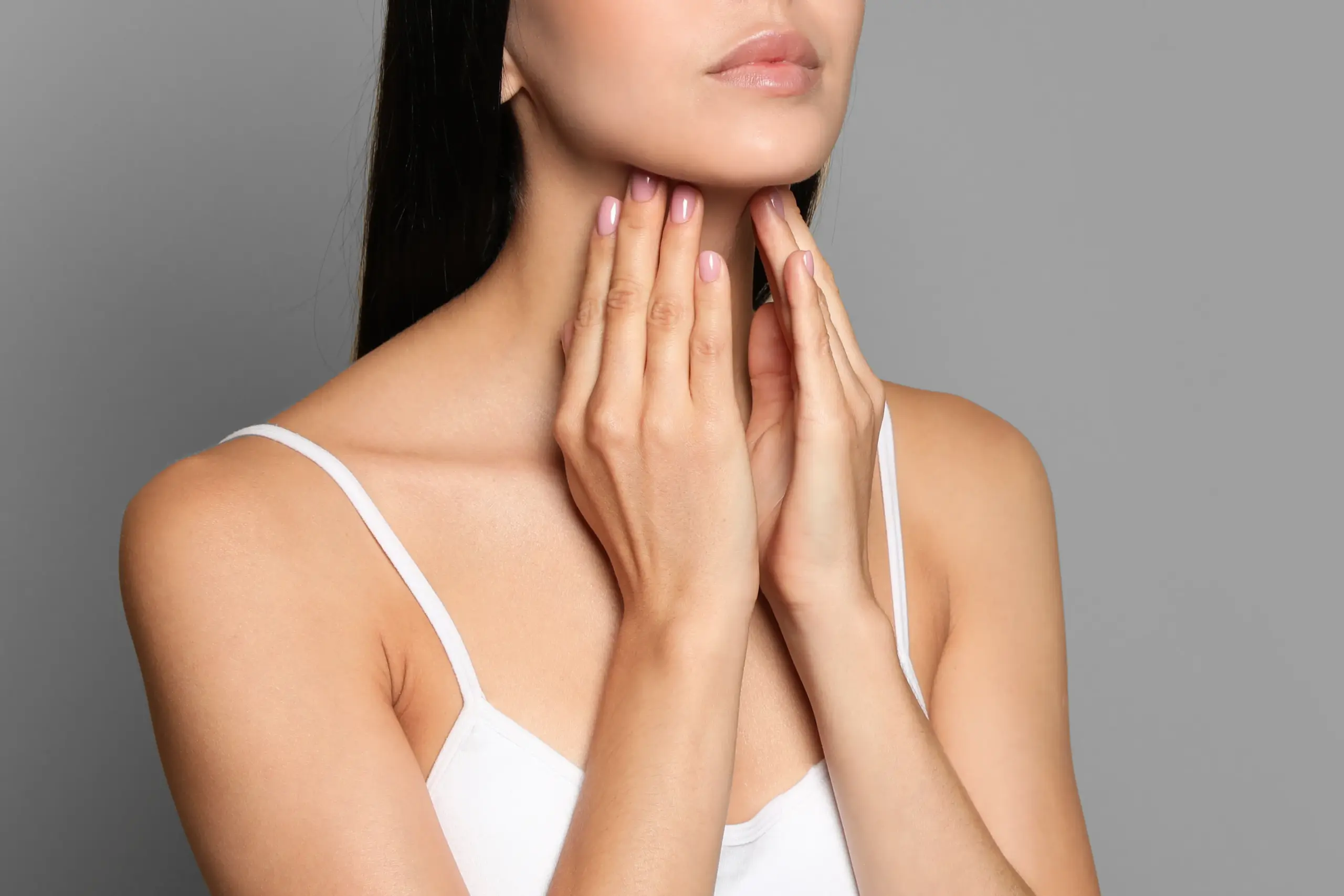Thyroid-Doctor A woman in a white tank top touches her neck looking for signs of thyroid disorder. Get help for thyroid disorders from Sandra McDonald, NP in Southwestern Ontario.